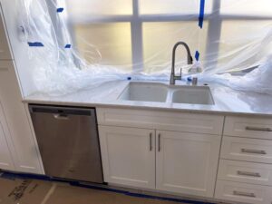 Roseville kitchen remodel with comprehensive plumbing services, protected by meticulous plastic covering.
